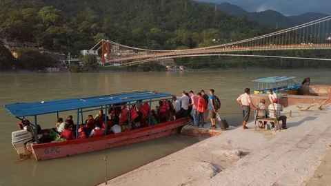 View of Ganga river in Rishikesh. People cross the river Ganga by boat. Stock Footage 119052533