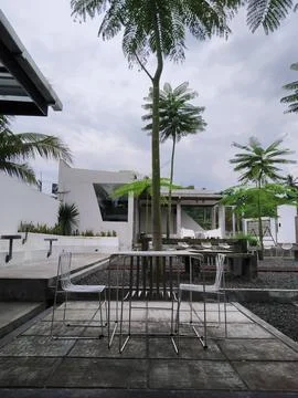View of garden cafe and empty iron chairs 스톡 사진