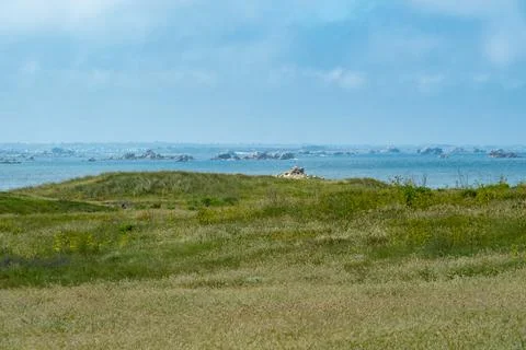 View from the gardens and fields of ile de Batz to the French coastline. Stock Photos