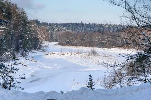 View of the Gauja River covered with ice and snow from a high bank in Latvia. Stock Photos