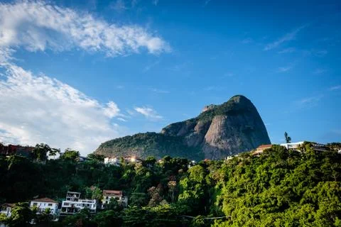 View of the Gavea Stone, seen from below with houses on the hill during late  Stock Photos
