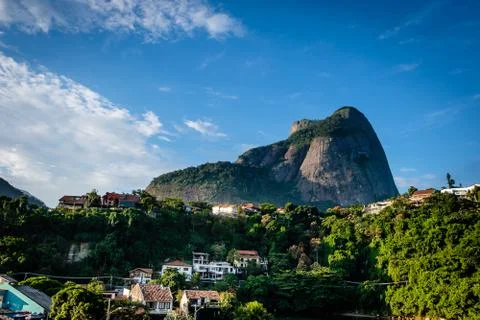 View of the Gavea Stone, seen from below with houses on the hill during late  Stock Photos