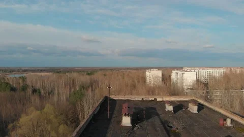 View of ghost city of Pripyat with Chernobyl nuclear power plant and sarcophagus Stock Footage 159265370