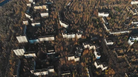 View of ghost city of Pripyat with Chernobyl nuclear power plant and sarcophagus Stock Footage 159265566