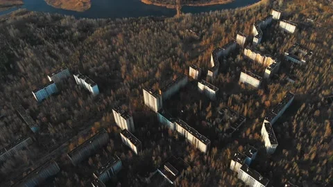 View of ghost city of Pripyat with Chernobyl nuclear power plant and sarcophagus Stock Footage 159265698