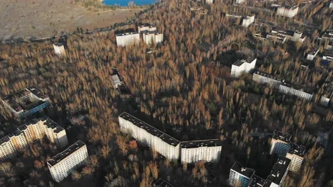 View of ghost city of Pripyat with Chernobyl nuclear power plant and sarcophagus Stock Footage 159265733