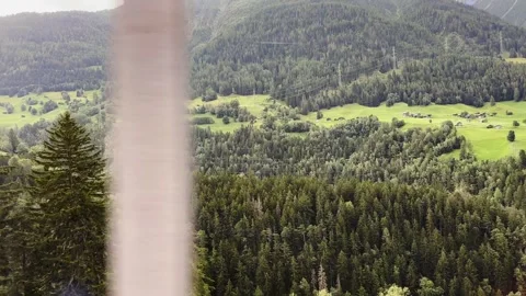 View From Glacier Express Train on a Beautiful Village and Mountainscape Stockbeeldmateriaal 287212279