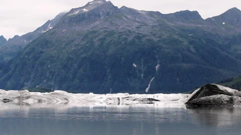 View of glacier ice dissolving into freshwater lake Stock Footage 332186910