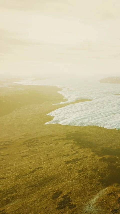 View of a glacier melting into a wide river under a cloudy sky Stock Footage 342710700