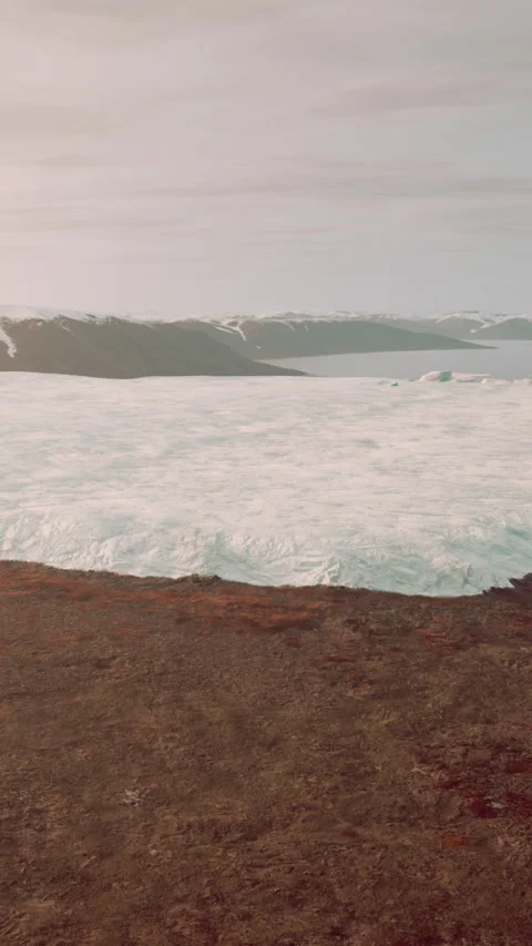 View of a glacier with mountains in the background during daylight hours Stock Footage 341983834
