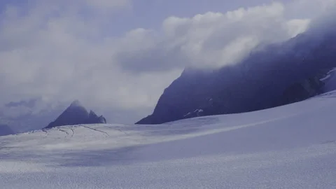 View of the glacier from the top of the mountain, covered with running clouds Stock Footage 318597912