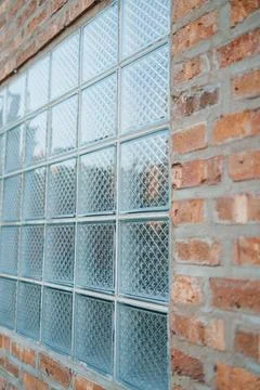 View of a glass block window set into an old brick wall during the day Fotos Stock