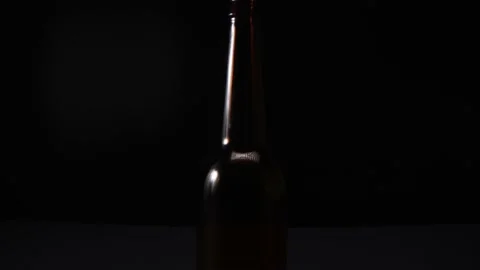 View of a glass bottle on a dark background Stock Footage 167789012