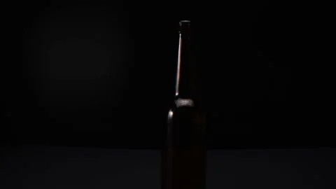 View of a glass bottle on a dark background Stock Footage 168059903
