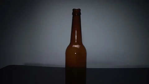 View of a glass bottle on a dark background Stock Footage 169873139