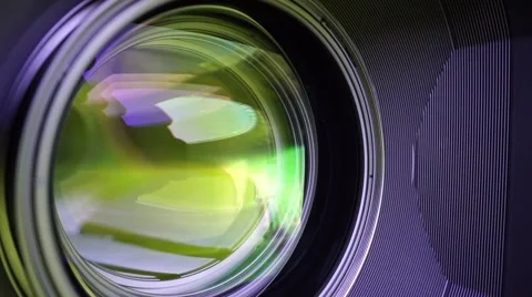 View of the glass elements in a camera lens. Objective under yellow light. Tilt Video stock 68151696