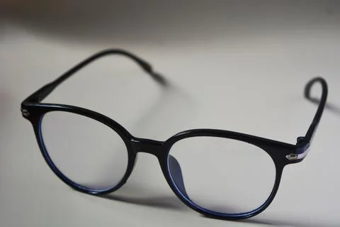 View of glasses with black frames, white background. Stock Photos