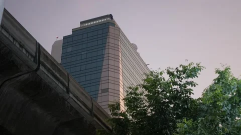 View to the glasses office building in sunset time with sky train railway Stock-Footage 206771084