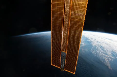 View of golden solar array with Earth limb in the background taken by the E.. Stock Photos