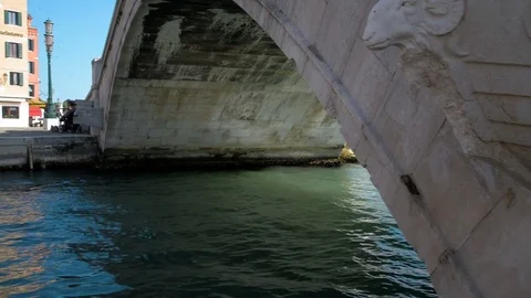 View from a gondola as it glides under a bridge in canal Stock Footage 76839382