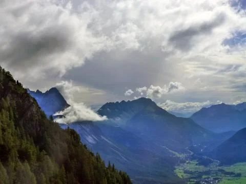 A view of the gorge between the forest-covered mountains at the bottom Stock Photos