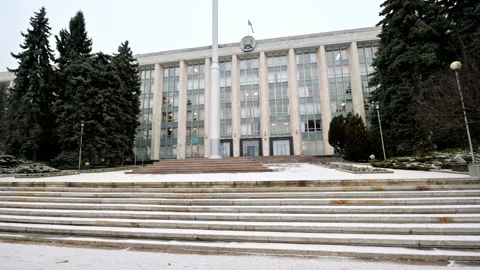 View of government building during a snowfall in Chisinau, Moldova. Flag, Stock Footage 229739093