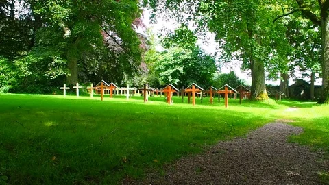 View of the graveyard of the Pluscarden Abbey, Scotland Stock Footage 79685196