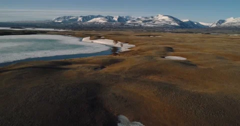 View of Great Altai Range from Mongolia. Spring landscape with frozen lake Stock Footage 194135294