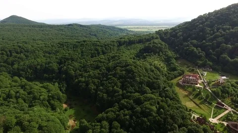 View from a great height on a big forest and the high peaks of forested Stock Footage 72794316