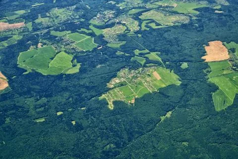 View from a great height to plain covered with forest Stock Photos