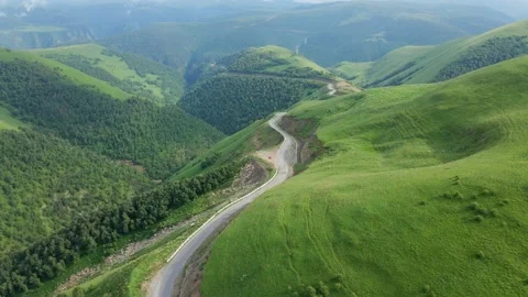 View of the green Caucasus mountains in summer from the sky Stock Footage 136433143