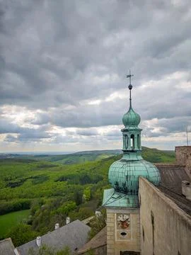 View of a green copper tower with clock on top of Buchlov Castle Stock Photos