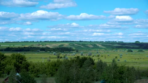 View of green fields and blue sky with clouds Stock Footage 123669319