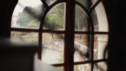 View of a green garden through an arched wooden window Stock Footage 333005291