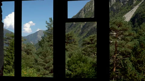 View of the green mountains from the window of an abandoned building. The camera Stock Footage 140276299