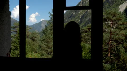 View of the green mountains from the window of an abandoned building. A young Stock Footage 140276598