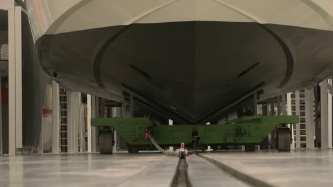 View from the ground of a boat being pulled with a chain in a shipyard Stock Footage 72143891