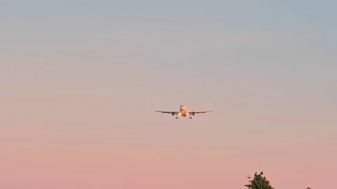 View from the ground on grounded airplane at sunset Видео 112561989