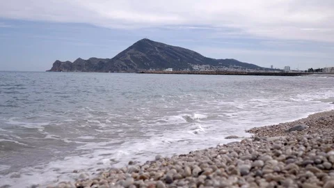 View at ground level of the beach with stones of Altea, Mediterranean sea in  Stock Footage 116103943