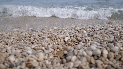 View at ground level of the beach with stones of Altea, Mediterranean sea in  Stockbeeldmateriaal 116104003