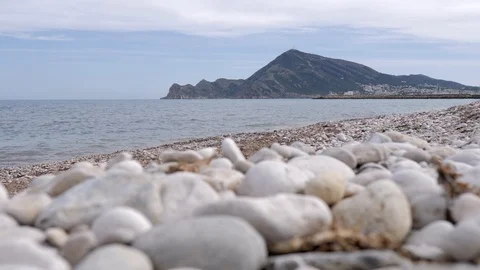 View at ground level of the beach with stones of Altea, Mediterranean sea in  Stockbeeldmateriaal 116104070