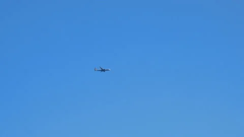 View from the ground on the plane in the blue sky in London, United Kingdom - 4K Stock Footage 196110355