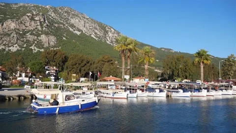 View Of A Group Of Boats On The River With A Mountain In The Background Stock Footage 195980261