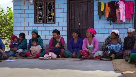 View of a group of people sitting outside a house in Surkhet, Nepal. Video stock 335467526