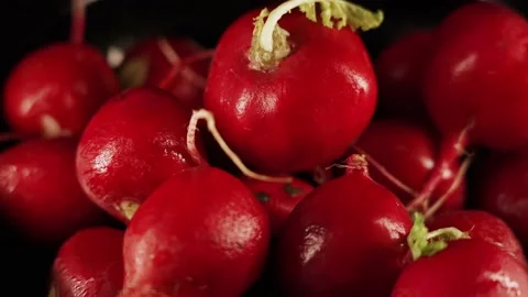 View group of radish rotate on a black background. Juicy ripe vegetable raph Stock Footage 229235728