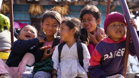 View of a group of smiling children sitting on stairs, Nepal. Video stock 335467740