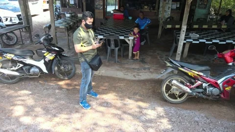 View of guy playing with remote control in front of shop in Kedah Video stock 152597526