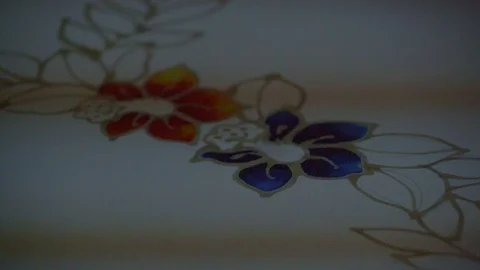 View of a hand Drawing flower design in wax prior to dyeing - Penang, Malaysia Stock Footage 120400183
