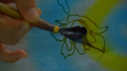 View of a hand Drawing pattern in wax prior to dyeing in Batik factory Malaysia Stock Footage 108798404