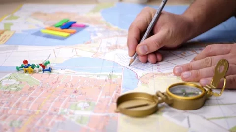 View of a hand holding compass and map as background. searching direction w.. Stock Footage 257872864